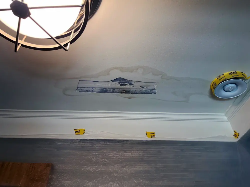 Ceiling before drywall repair — stained and cracked