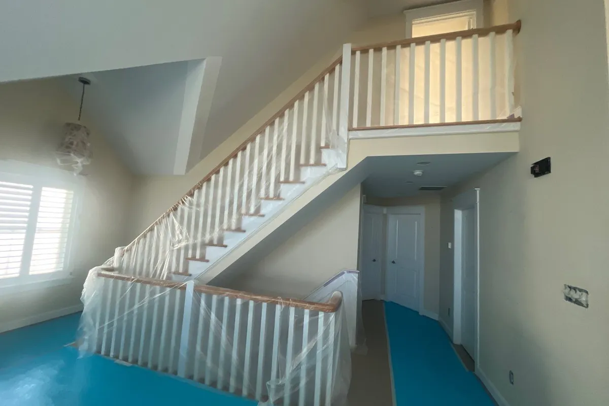 Repaired drywall areas visible along a hallway wall