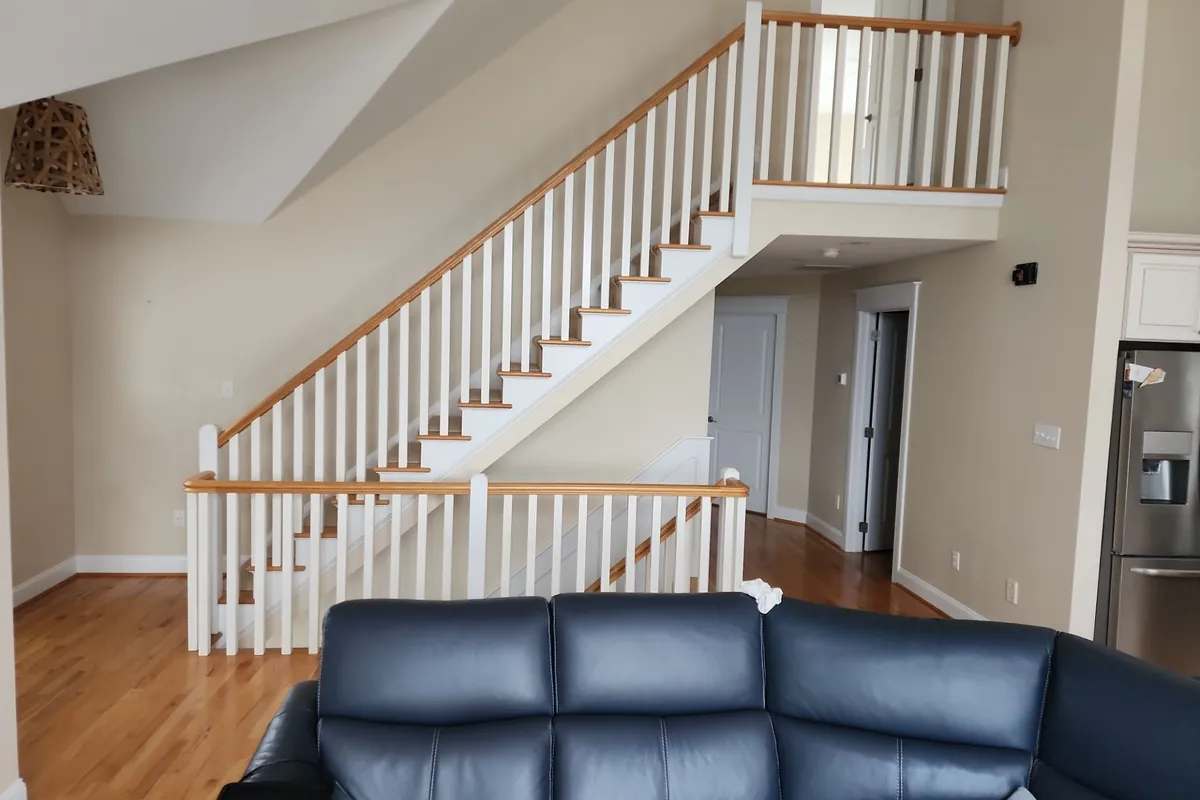 Freshly painted staircase and railings after drywall repair